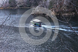 Boat goes by the river in Matka Canyon