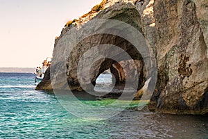 Boat going through the blue caves in Zakynthos island in Greece.