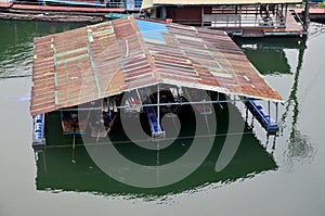 Boat house keeping long tail boats in Samprasob River