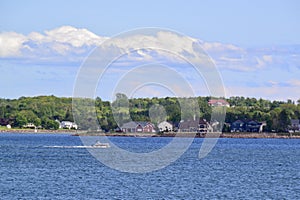 Boat and houses along the shore of Charlottetown Harbour