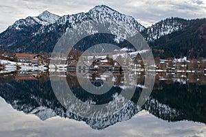 The boat huts are reflected in the Schliersee