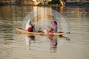 Boat and indian people in Dal lake. Srinagar, Jammu and Kashmir state, India