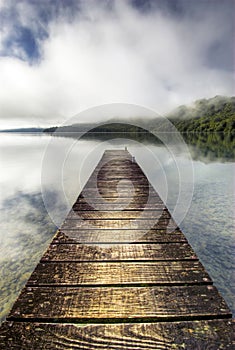 Boat jetty and calm lake, New Zealand