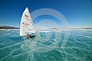 Boat for kitewing frozen ice on a beautiful lake on a background of blue sky