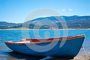 Boat on lake Batak with Mountains in the distance. photo