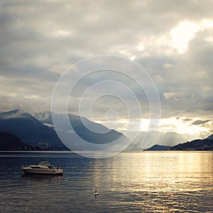 Boat on Lake Como at the sunset. Silver linings.