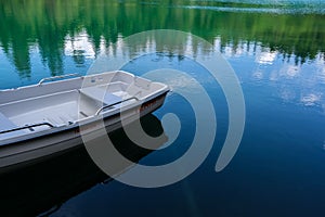 Boat in a lake in the Grisons Mountains in Switzerland