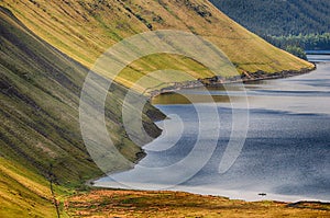 Boat in lake between hills