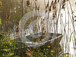 Boat on the lake in a misty morning