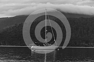 Boat on a lake with mountain backdrop