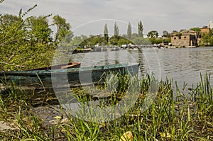 Boat on lake with a reflection in the water at sunset