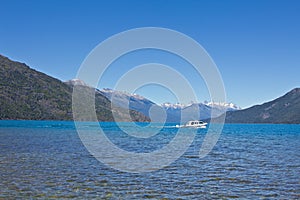 Boat at the lake side with mountain range in the background close to El BolsÃ³n. Perfect place for fly fishing, trekking, rafting