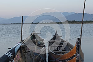 Boat in the lake at sunset. Rowing boat floating over the Limboto Lake waters. Gorontalo, Indonesia