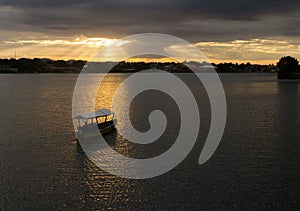 Boat in lake at sunset photo