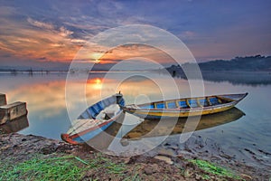 Boat at lake traditional transportation at sunsets