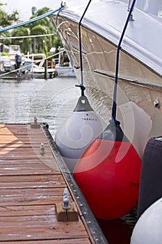 Boat with large fenders tied to dock