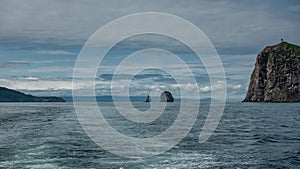 A boat leaves a foam trail on the ocean surface