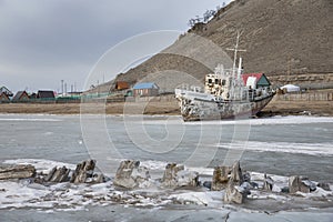 Boat locked in ice in a frozen lake Khuvsgul in northern Mongoli