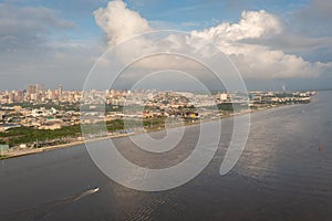 Boat on the Magdalena river with part of the city of Barranquilla in the background. Colombia.