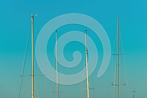 Boat masts against blue sky