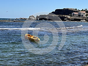 A small boat in the middle of the beach photo