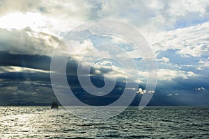 The boat in the mids of the ocean.