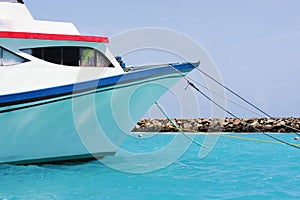 Boat moored in the blue sea of the Maldives islands