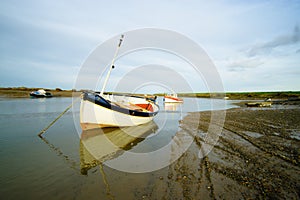 Boat moored at low tide.