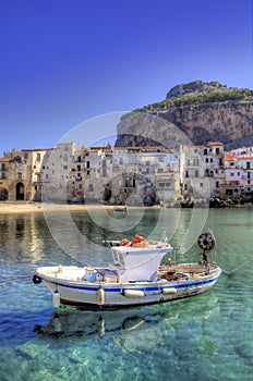 Boat Moored Outside the Beach of the Beautiful Fishing Village of Cefalu on Sicily, Italy