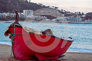 Boat moored on the shore of Blanes beach.
