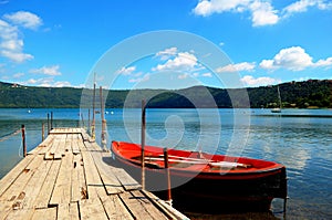 Boat moored to dock in lake