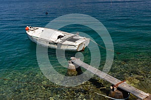 boat moored at the wooden pier in harbour of Losinj town, Croatia