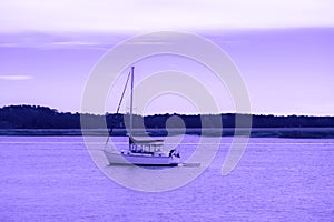 Boat. Motor boat in a river on a violet sky and reflection to river