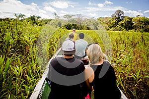 Boat navigating in the dense jungle at amazon river