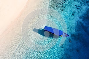 Boat near the beach. Seascape from drone. Blue water background from top view. Gili Meno island, Indonesia.