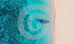 Boat near beach from top view. Turquoise water background from top view. Summer seascape from air. Gili Meno island, Indonesia. photo