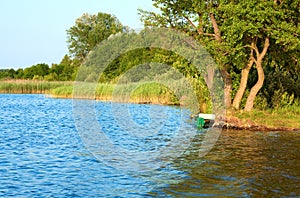 Boat near the summer lake shore