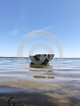 A boat with networks on the shore of the lake. Lake Naroch photo