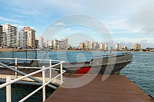 The boat next to the pier in the city Salinas on the Pacific coast of Ecuador.