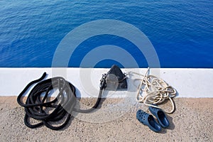 Boat noray marine rope and shoes in marina photo