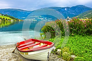 Boat in Norway fjords. Norwegian village Olden.