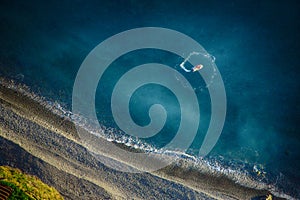 Boat in the ocean goes on spiral is not far from the coast