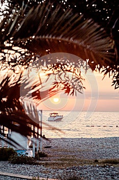 Boat off the coast at sunset