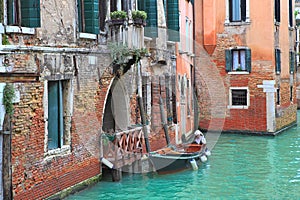 Boat and old brick house in Venice, Italy.