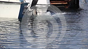 Boat outboard motor in water running at dock