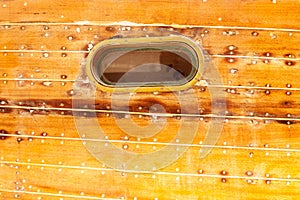 Boat oval porthole in wooden hull