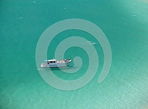 Boat over a crystalline turquoise beach