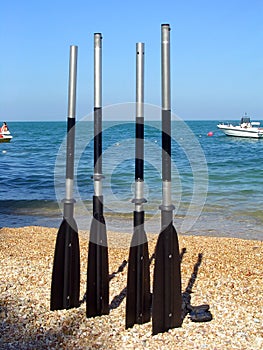 Boat paddles on a beach photo