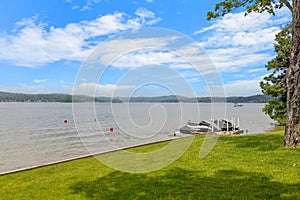 a boat parked at the edge of a lake in the day,  in Lakeport New Hampshire.