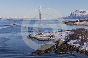 Boat passing the Tjeldsundet strait which separates the mainland